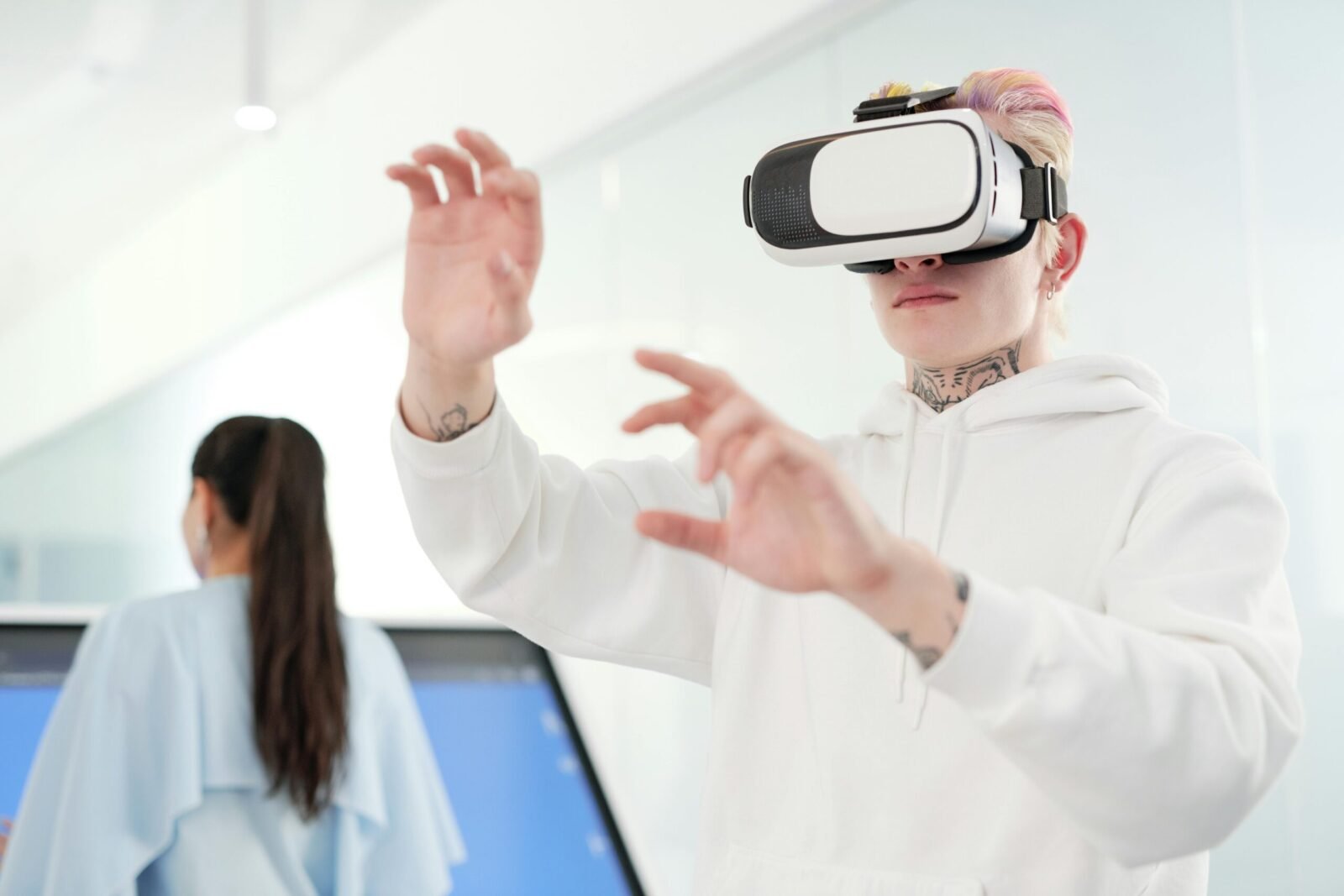 Young man wearing VR headset inside a modern space exploring virtual reality.